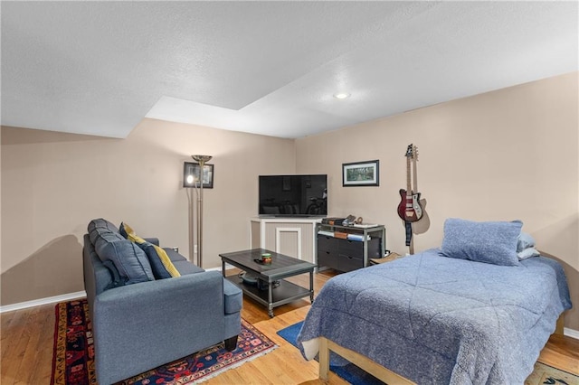 808 S Mohican Dr, Independence, MO 64056 - bedroom with light wood-style floors, baseboards, and a textured ceiling