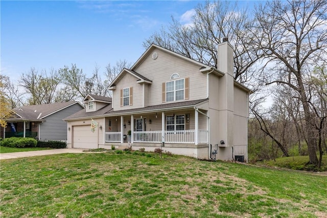 808 S Mohican Dr, Independence, MO 64056 - view of front facade featuring a porch, an attached garage, driveway, and a front lawn