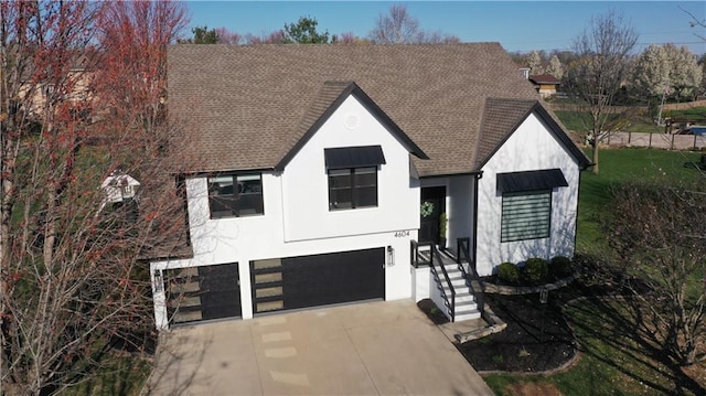 view of front of home featuring an attached garage, stucco siding, a shingled roof, and concrete driveway