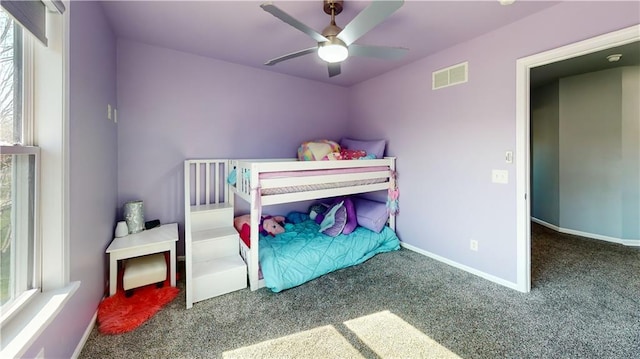 bedroom with carpet floors, baseboards, ceiling fan, and visible vents