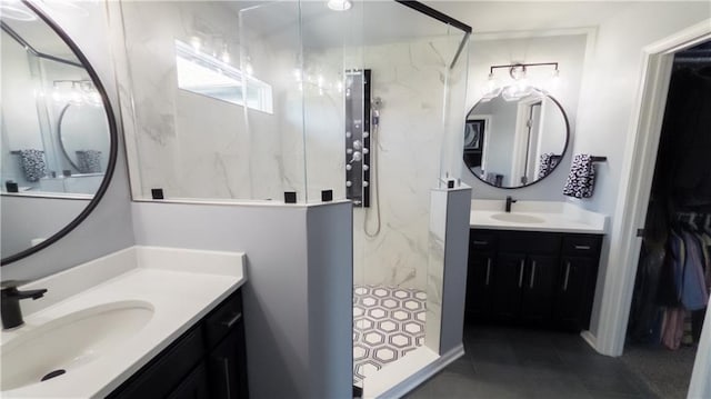bathroom featuring a sink, two vanities, and a marble finish shower