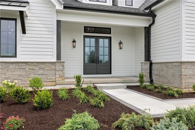 17216 Goddard St, Overland Park, KS 66221 - view of exterior entry with a porch, french doors, and stone siding