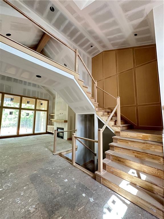 17216 Goddard St, Overland Park, KS 66221 - stairway with a fireplace and vaulted ceiling
