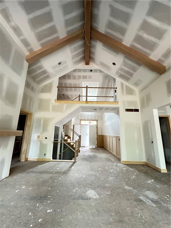 17216 Goddard St, Overland Park, KS 66221 - unfurnished living room with high vaulted ceiling and stairway