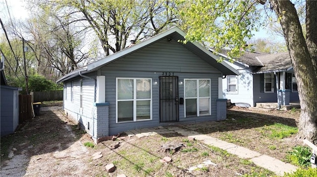2907 E 61st St, Kansas City, MO 64130 - rear view of house with fence