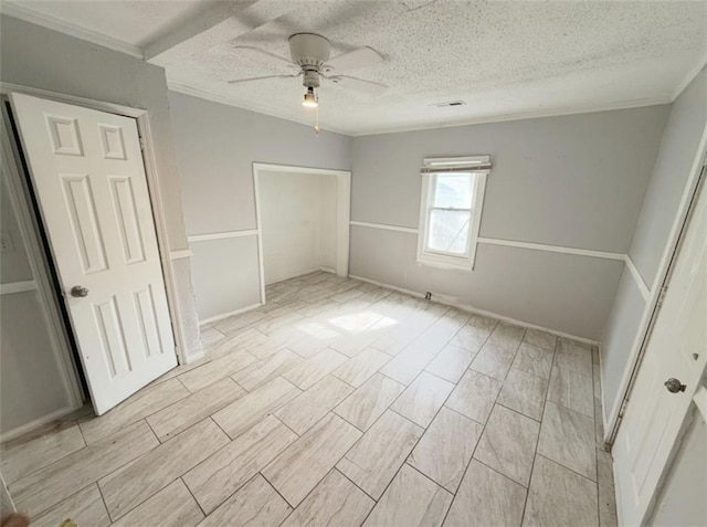 2907 E 61st St, Kansas City, MO 64130 - unfurnished bedroom featuring crown molding, a textured ceiling, a closet, and a ceiling fan