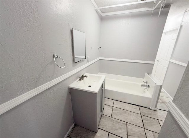 2907 E 61st St, Kansas City, MO 64130 - full bathroom with a textured wall, a bath, and vanity