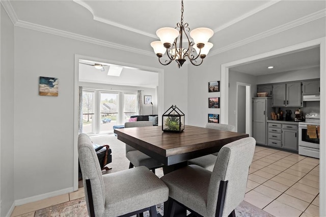 dining room featuring crown molding, bar, a chandelier, light tile patterned floors, and a tray ceiling