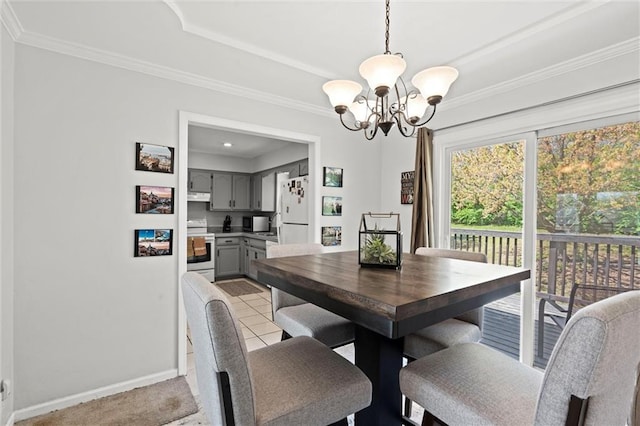 dining area with crown molding, baseboards, and a chandelier
