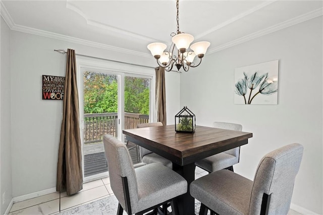 dining room featuring baseboards, ornamental molding, and a chandelier