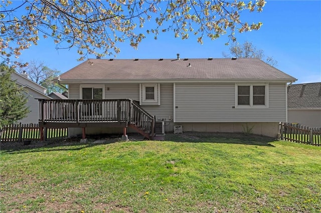 rear view of house featuring a fenced backyard, a yard, and a deck