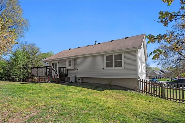 rear view of property featuring stairs, fence, a yard, and a wooden deck