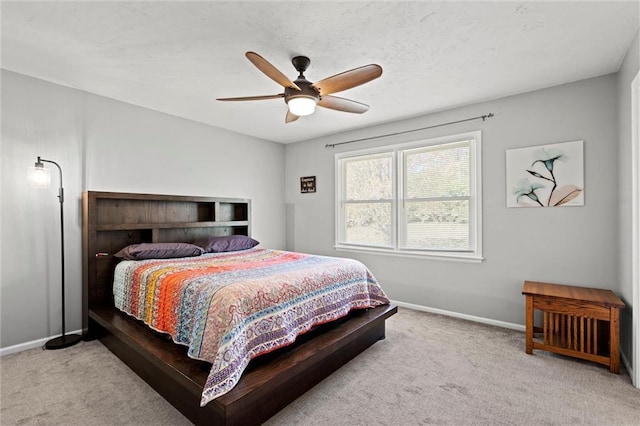 bedroom with baseboards, carpet flooring, and ceiling fan