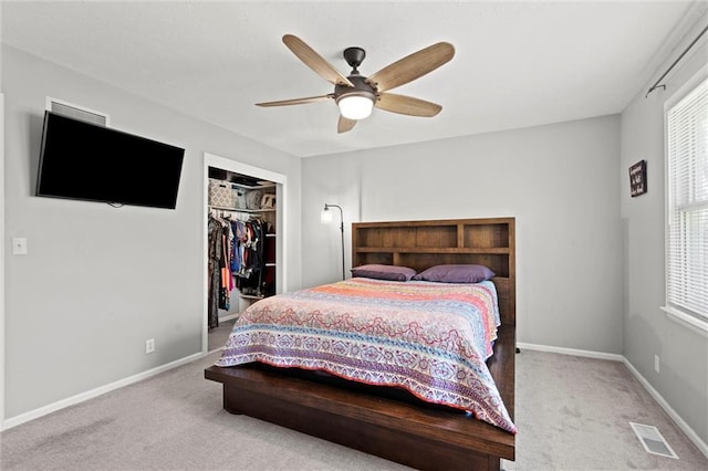 carpeted bedroom with ceiling fan, visible vents, baseboards, and a closet