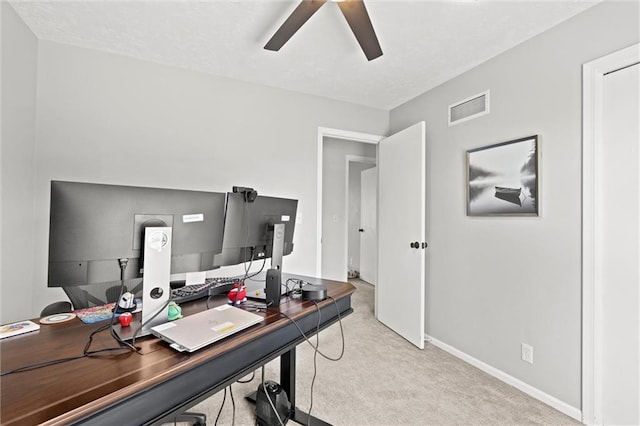 home office with ceiling fan, visible vents, light carpet, and baseboards
