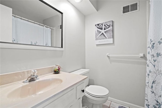 bathroom featuring visible vents, vanity, toilet, baseboards, and tile patterned floors
