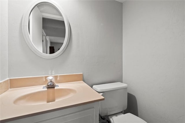 bathroom with toilet and vanity