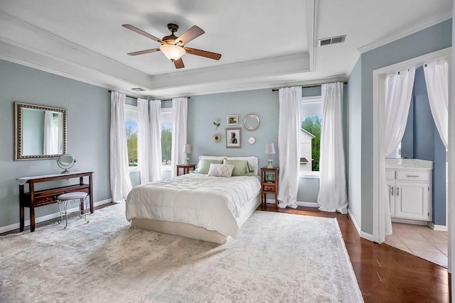 9011 NE 91st Ter, Kansas City, MO 64157 - bedroom with ornamental molding, a raised ceiling, dark wood-style flooring, and baseboards
