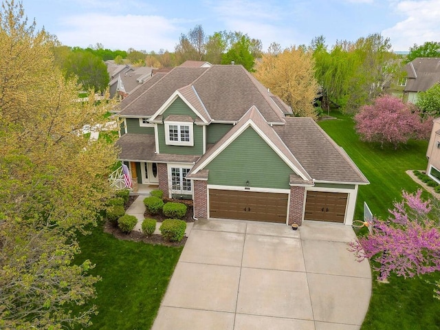 9011 NE 91st Ter, Kansas City, MO 64157 - view of front of home featuring driveway, a front lawn, a garage, and a shingled roof