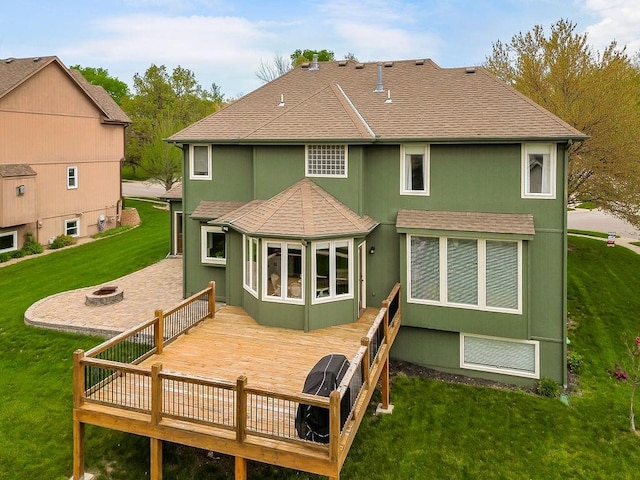 9011 NE 91st Ter, Kansas City, MO 64157 - back of property with an outdoor fire pit, a wooden deck, a shingled roof, and a yard
