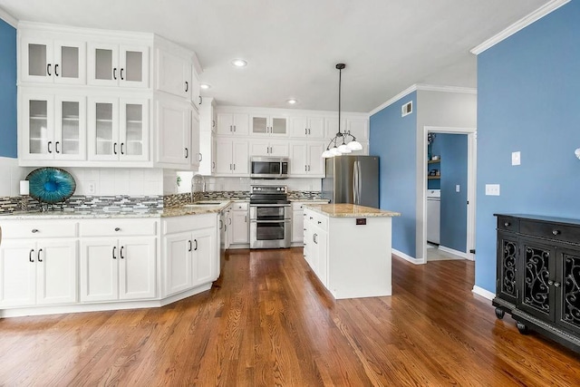 9011 NE 91st Ter, Kansas City, MO 64157 - kitchen featuring appliances with stainless steel finishes, a sink, white cabinets, backsplash, and ornamental molding