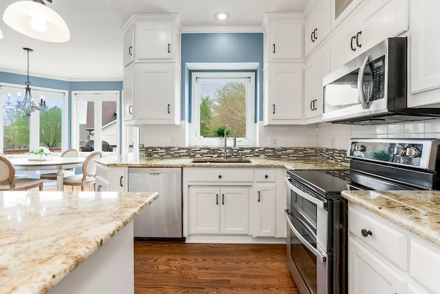 9011 NE 91st Ter, Kansas City, MO 64157 - kitchen with appliances with stainless steel finishes, a sink, crown molding, dark wood finished floors, and a chandelier