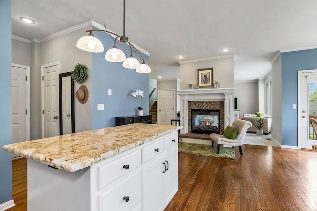 9011 NE 91st Ter, Kansas City, MO 64157 - kitchen featuring dark wood-style floors, ornamental molding, white cabinets, recessed lighting, and light stone countertops