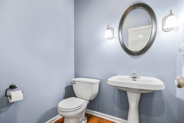 9011 NE 91st Ter, Kansas City, MO 64157 - bathroom featuring toilet, wood finished floors, and baseboards