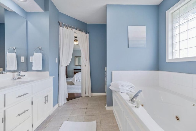 9011 NE 91st Ter, Kansas City, MO 64157 - bathroom featuring a tub with jets, vanity, tile patterned flooring, and baseboards
