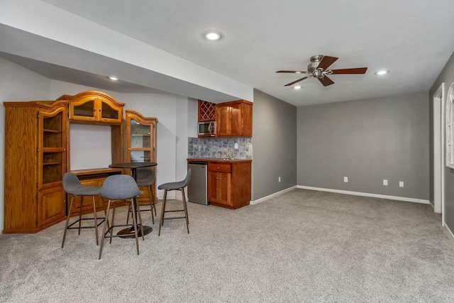 9011 NE 91st Ter, Kansas City, MO 64157 - kitchen featuring dishwasher, light colored carpet, stainless steel microwave, baseboards, and recessed lighting
