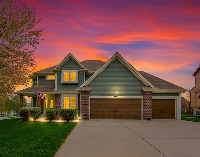 9011 NE 91st Ter, Kansas City, MO 64157 - view of front of house with driveway, an attached garage, a yard, and brick siding