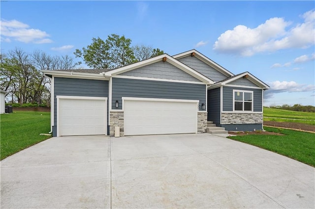 1001 Branchwood Ln, Raymore, MO 64083 - craftsman-style home with concrete driveway, a front yard, stone siding, and a garage