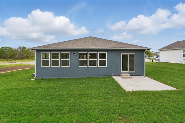1001 Branchwood Ln, Raymore, MO 64083 - back of property featuring a shingled roof, a yard, and a patio area