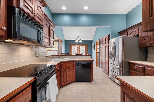 16011 Cedar St, Basehor, KS 66007 - kitchen featuring black appliances, light countertops, tasteful backsplash, lofted ceiling, and hanging light fixtures