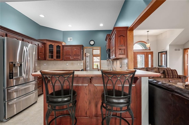 16011 Cedar St, Basehor, KS 66007 - kitchen with stainless steel fridge, open floor plan, backsplash, a peninsula, and a kitchen breakfast bar