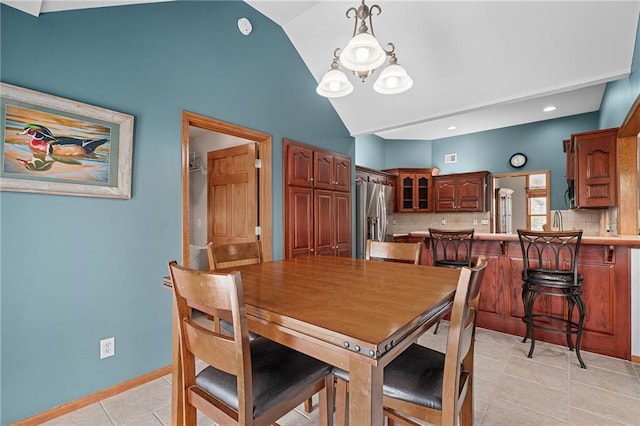 16011 Cedar St, Basehor, KS 66007 - dining room featuring light tile patterned floors, high vaulted ceiling, and a chandelier