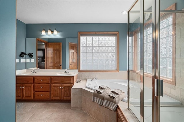 16011 Cedar St, Basehor, KS 66007 - full bathroom featuring healthy amount of natural light, double vanity, a bath, and tile patterned flooring