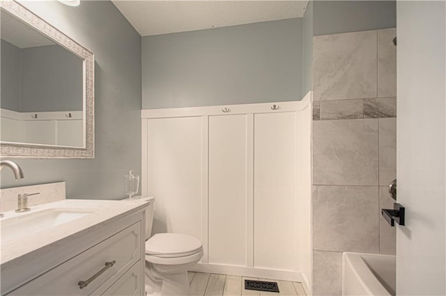 310 E 22nd St, Kearney, MO 64060 - full bathroom featuring toilet, vanity, tile patterned floors, and visible vents