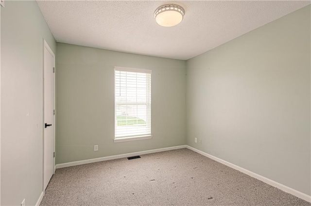 310 E 22nd St, Kearney, MO 64060 - unfurnished room with baseboards, a textured ceiling, and carpet floors