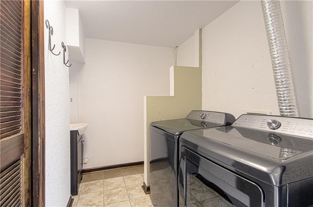 310 E 22nd St, Kearney, MO 64060 - washroom with separate washer and dryer, baseboards, laundry area, and light tile patterned floors
