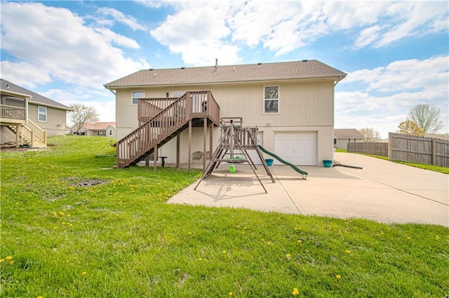 310 E 22nd St, Kearney, MO 64060 - back of house featuring a wooden deck, a garage, stairs, and fence