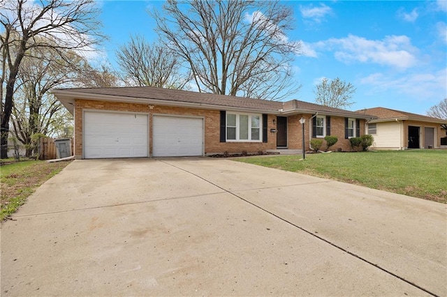 108 W Walnut St, Blue Springs, MO 64015 - ranch-style house with an attached garage, concrete driveway, a front lawn, and brick siding