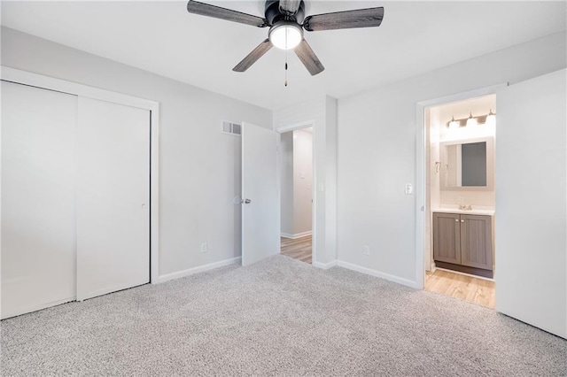 108 W Walnut St, Blue Springs, MO 64015 - unfurnished bedroom featuring visible vents, ensuite bathroom, a closet, a sink, and light colored carpet