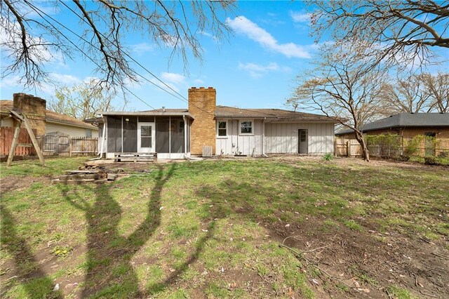 108 W Walnut St, Blue Springs, MO 64015 - rear view of property with a yard, fence, a sunroom, and a chimney