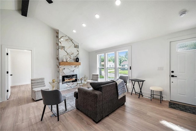 714 N Rogers St, Independence, MO 64050 - living area with a high end fireplace, light wood-style flooring, high vaulted ceiling, beamed ceiling, and recessed lighting