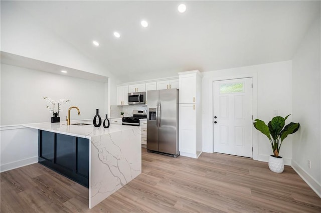 714 N Rogers St, Independence, MO 64050 - kitchen with stainless steel appliances, white cabinets, recessed lighting, light wood finished floors, and light stone counters