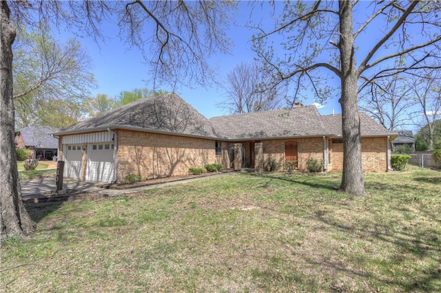 2301 S Stilwell St, Pittsburg, KS 66762 - view of front of home with a garage, driveway, a front lawn, and brick siding