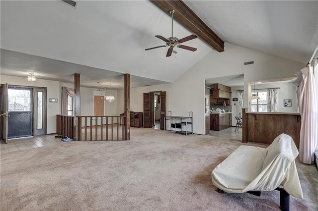 2301 S Stilwell St, Pittsburg, KS 66762 - carpeted living area with a healthy amount of sunlight, beam ceiling, a ceiling fan, and visible vents