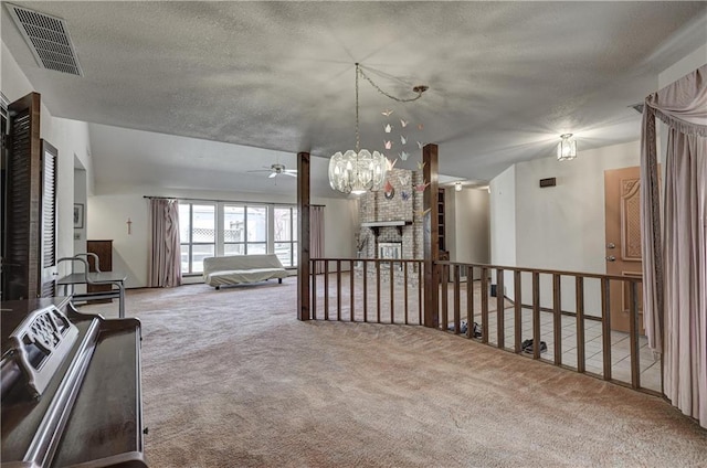 2301 S Stilwell St, Pittsburg, KS 66762 - interior space featuring visible vents, ceiling fan with notable chandelier, carpet floors, and a textured ceiling