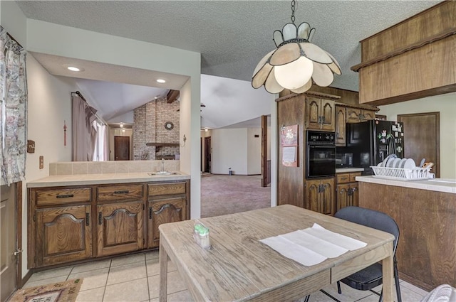 2301 S Stilwell St, Pittsburg, KS 66762 - kitchen featuring a sink, brown cabinets, black appliances, and lofted ceiling